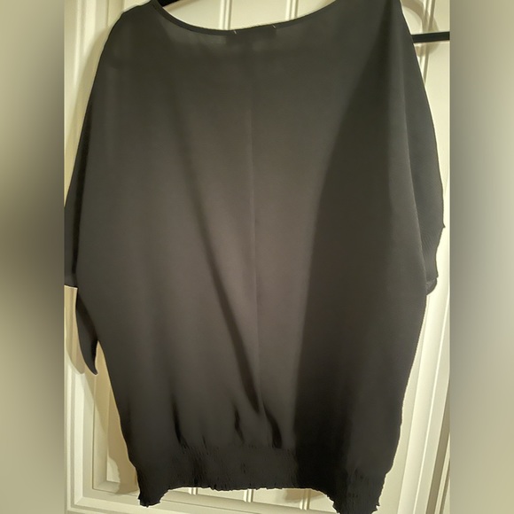 Ricki’s black blouse with arm cutouts. - Picture 3 of 4